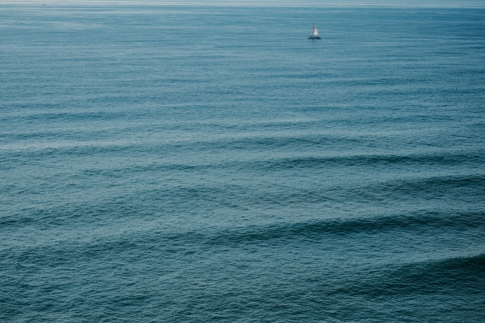 white sailboat on blue sea during daytime