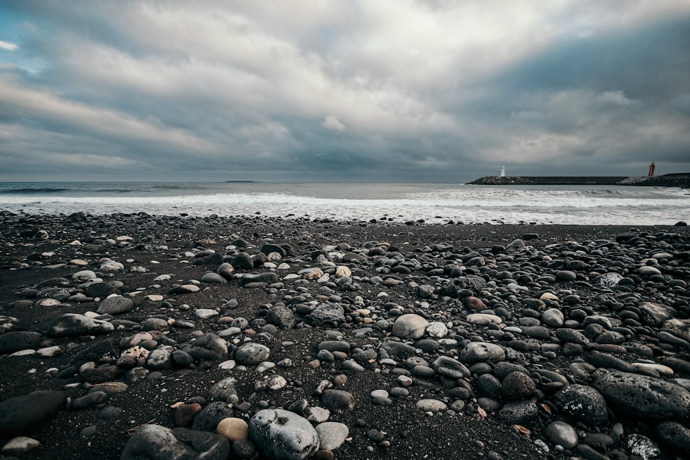 gray and white stones on seashore during daytime