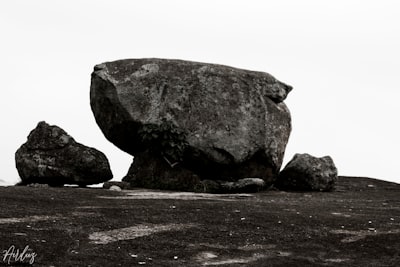 gray rock formation on brown sand during daytime rock zoom background