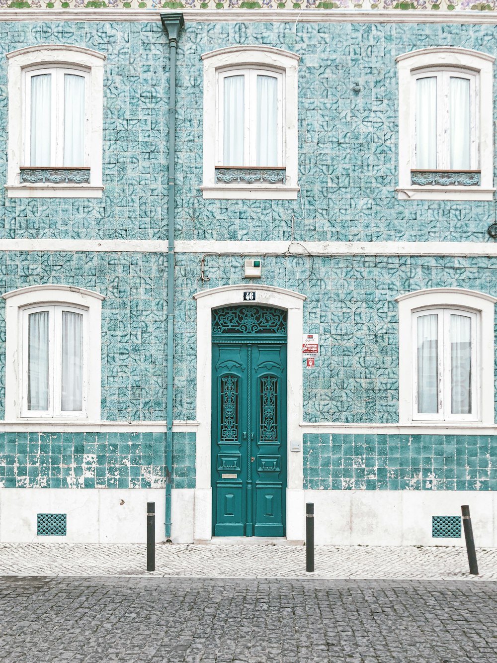 red wooden door on brown brick building