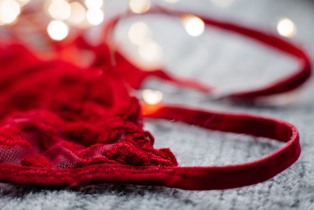 red and white textile on white textile