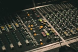 Mixing board with colorful knobs and sliders mid-session
