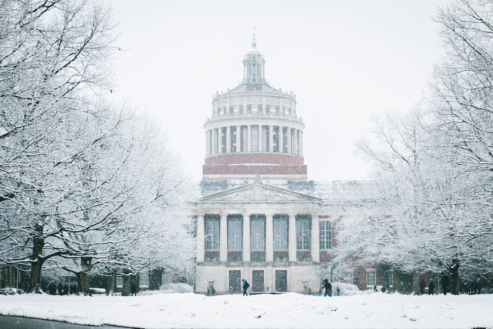 white concrete building surrounded by snow covered ground