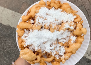 person holding brown round pastry