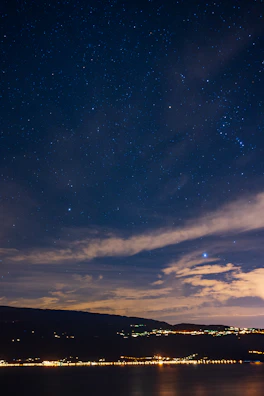 Xyrthara’s deep blue harbor under a star-studded night sky.
