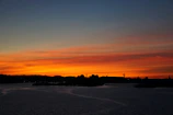 A vibrant sunset over Buffalo's skyline with Lake Erie in the foreground.