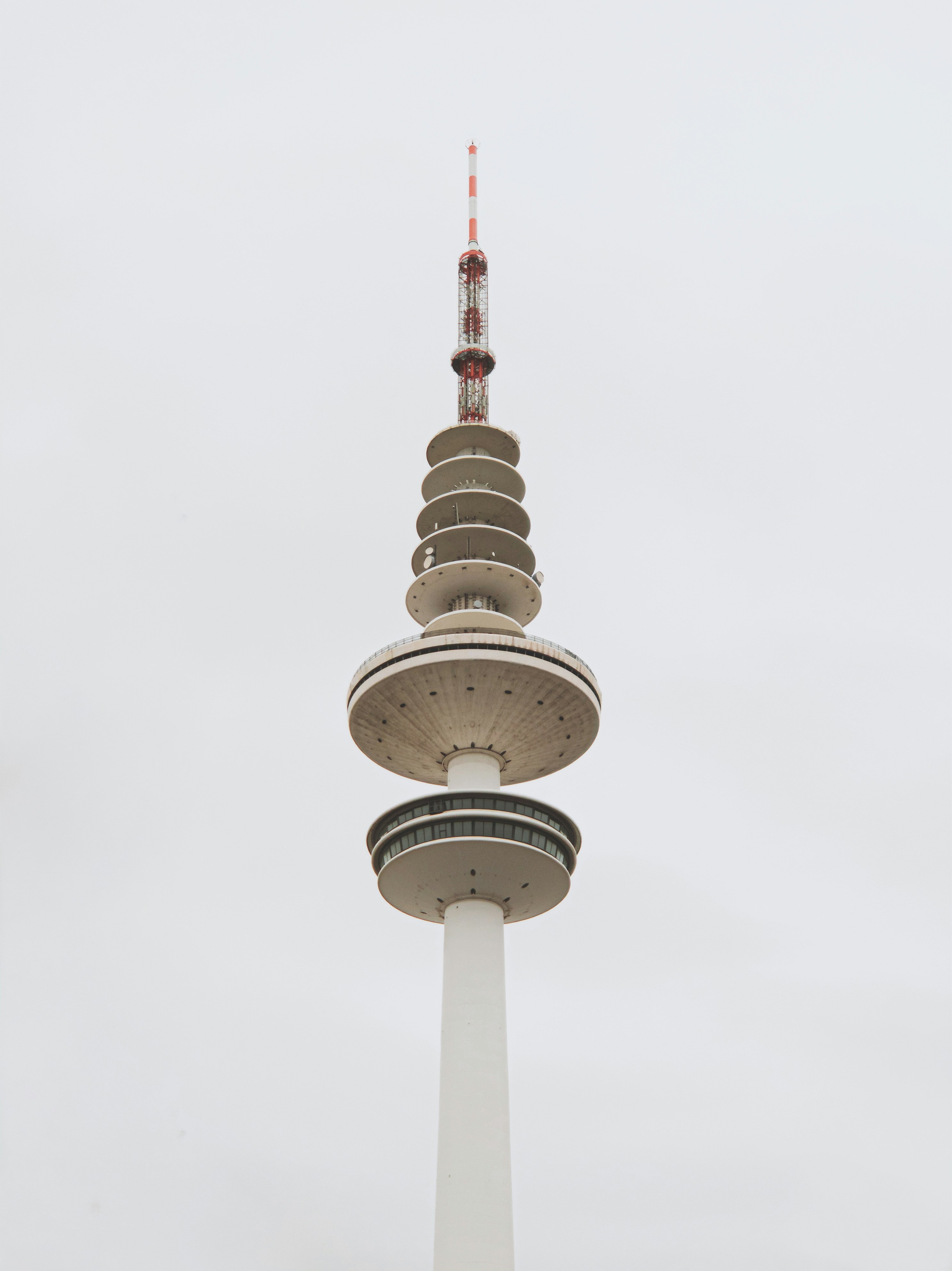 white and red tower under white sky