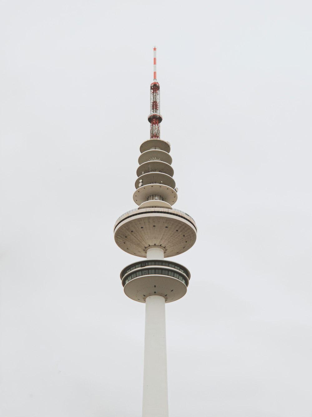 white and red tower under white sky