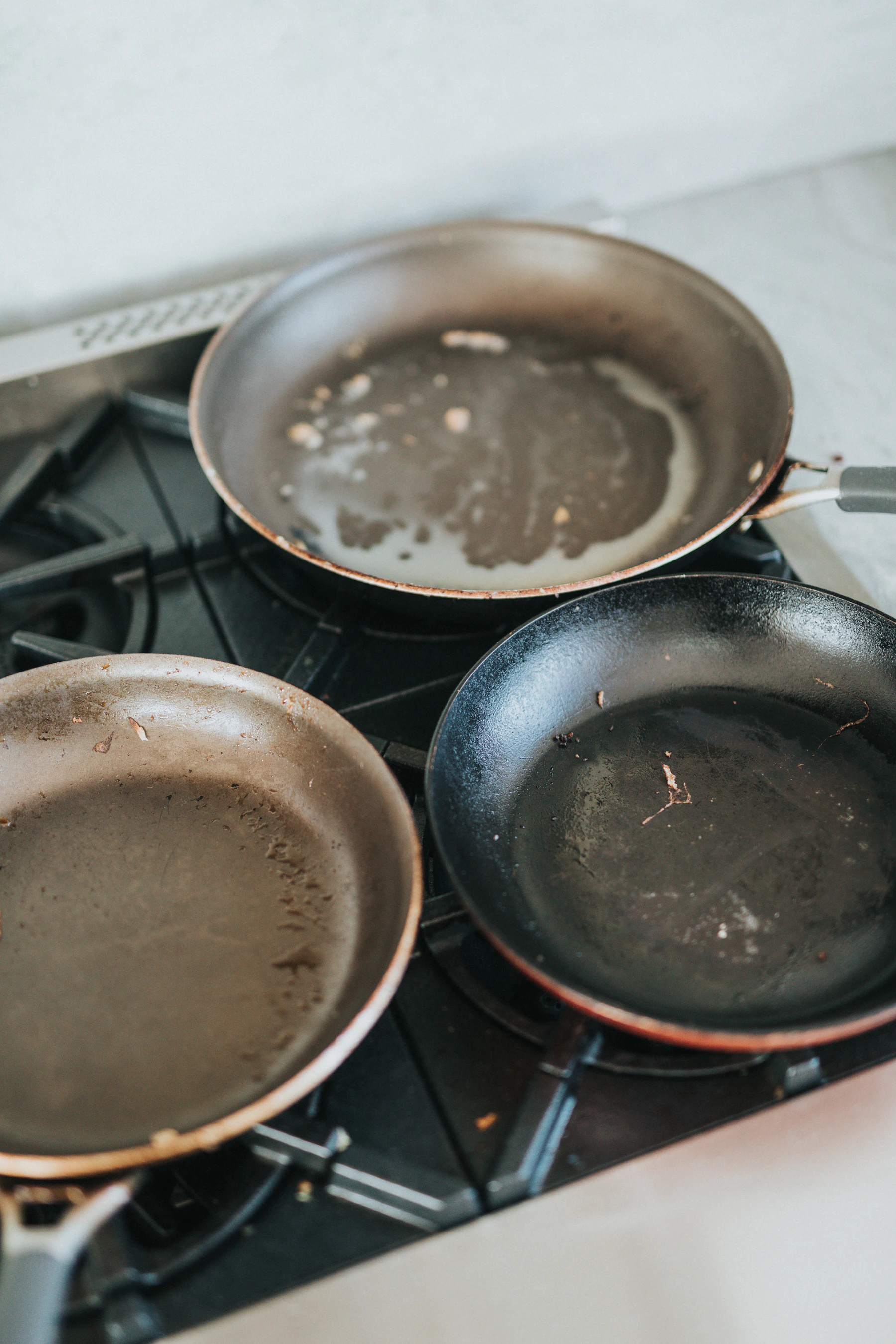 A selection of frying pans arranged on a kitchen stovetop
