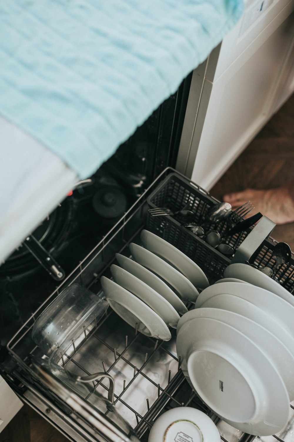 white ceramic plate on black dishwasher