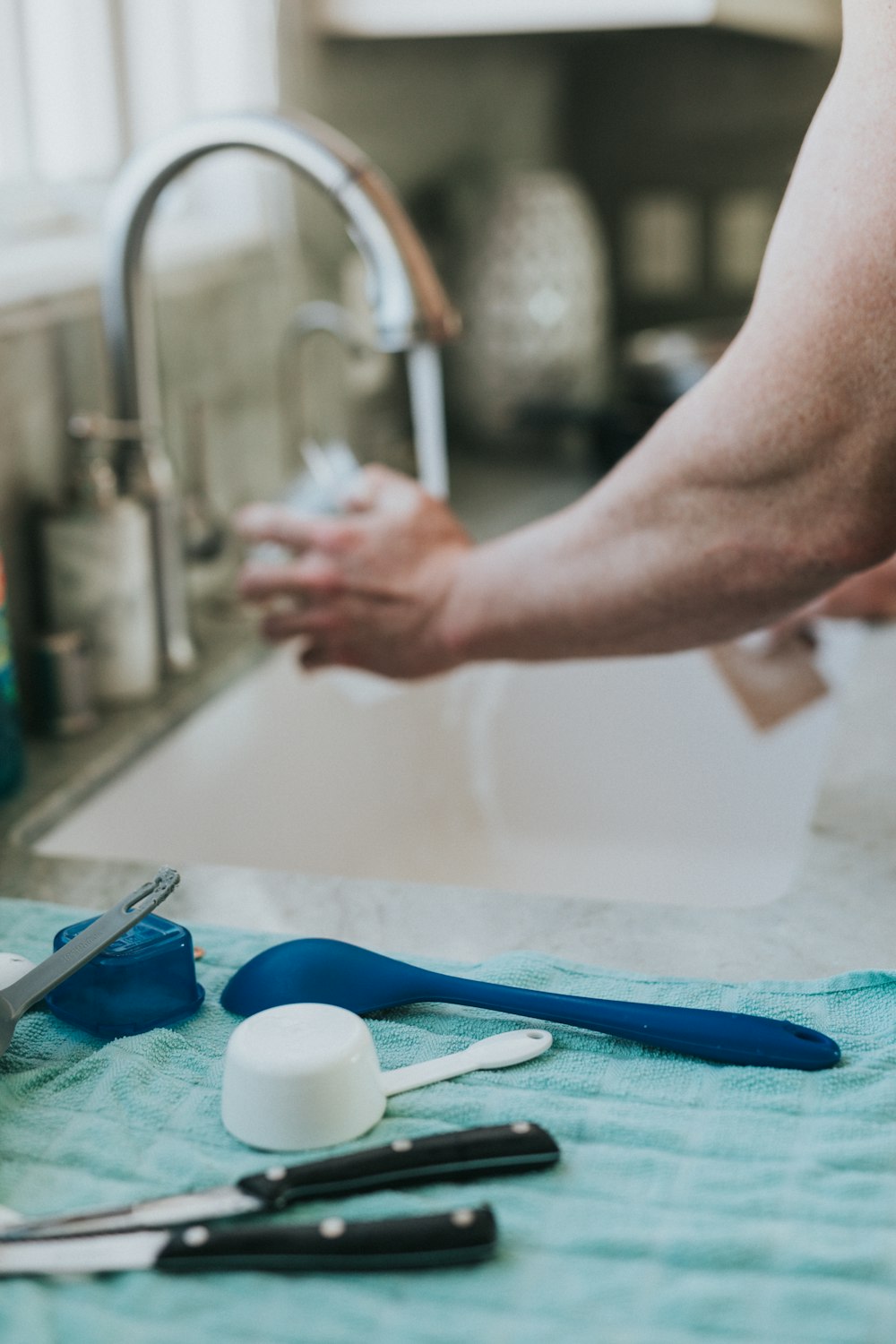 person washing hands on sink