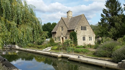 brown brick house beside river