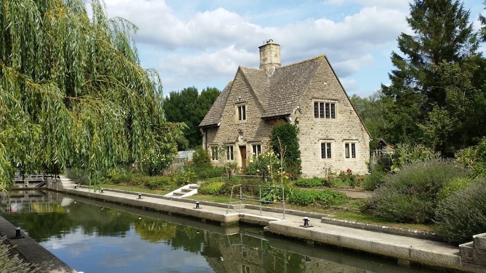 brown brick house beside river