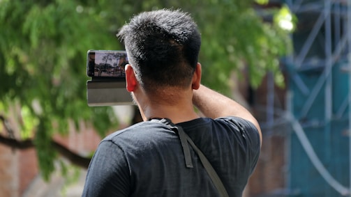 A person filming a short promotional video outdoors with a smartphone