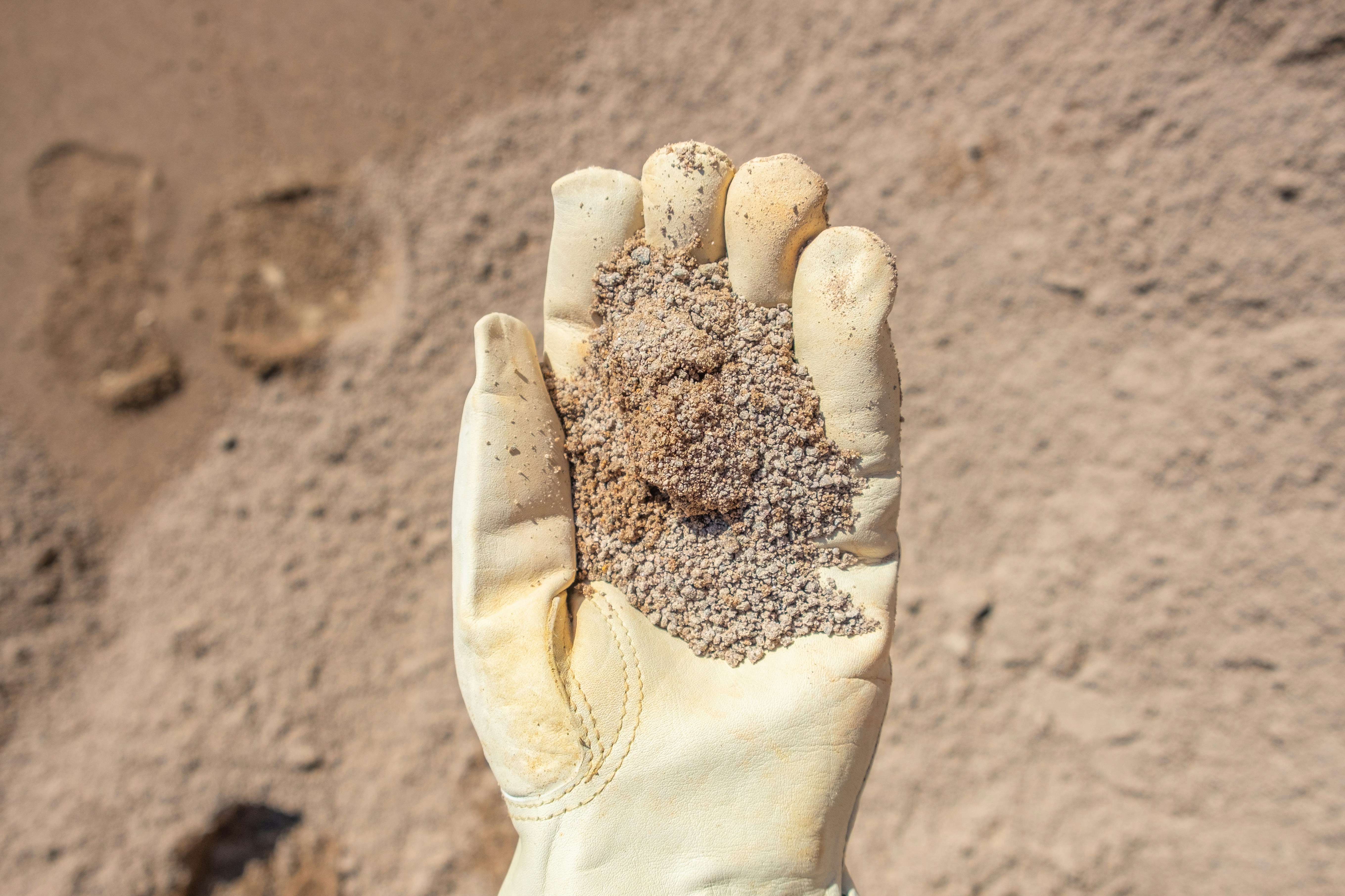 persons hand with white sand