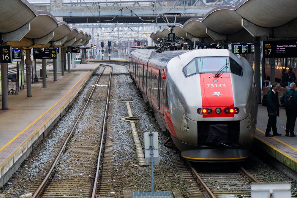 red and white train in train station