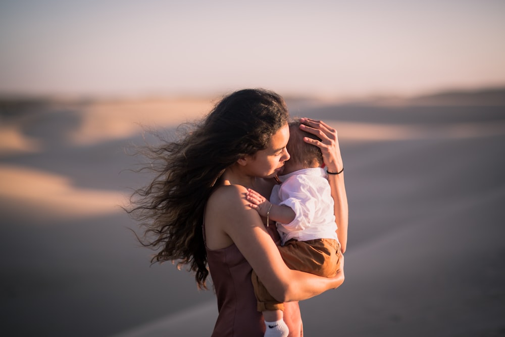 man in brown shorts carrying woman in white dress during daytime