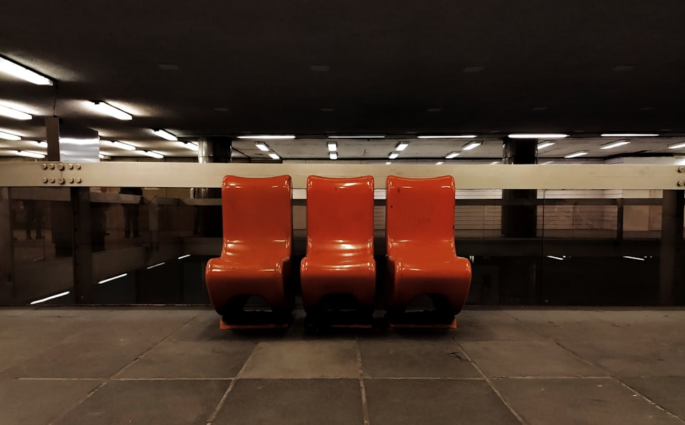 red plastic chairs on white floor tiles