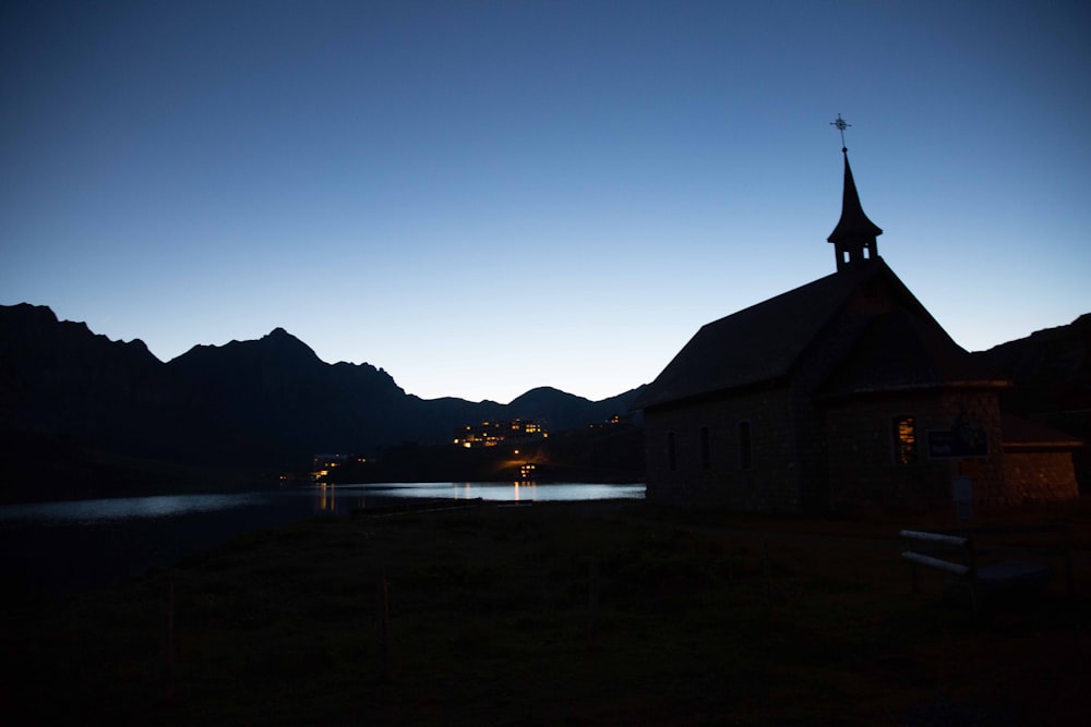 white and black church near body of water during night time