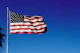 us a flag on pole under blue sky during daytime