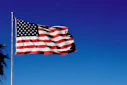us a flag on pole under blue sky during daytime