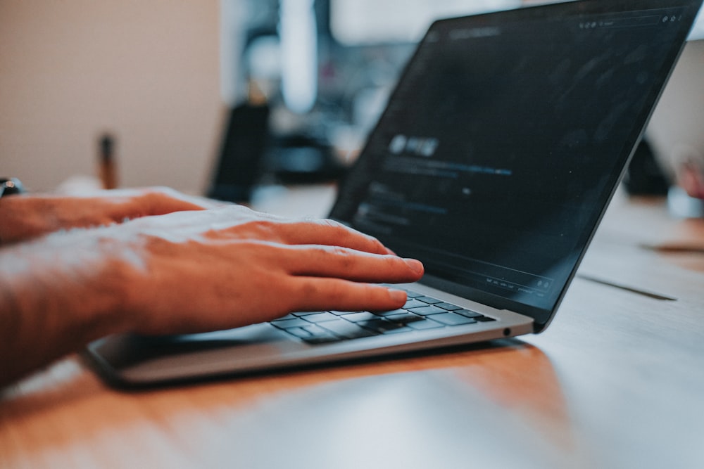 person using black laptop computer