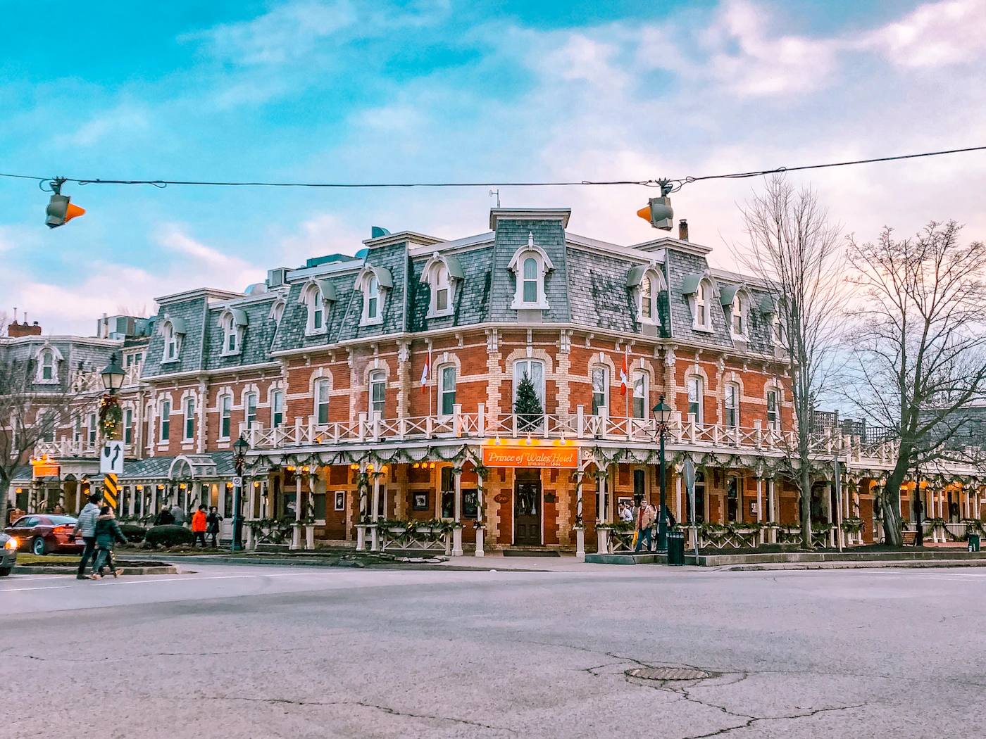 The Prince of Wales Hotel in Niagara-on-the-Lake, a Victorian red-brick landmark building with white dormers and covered porches on King Street