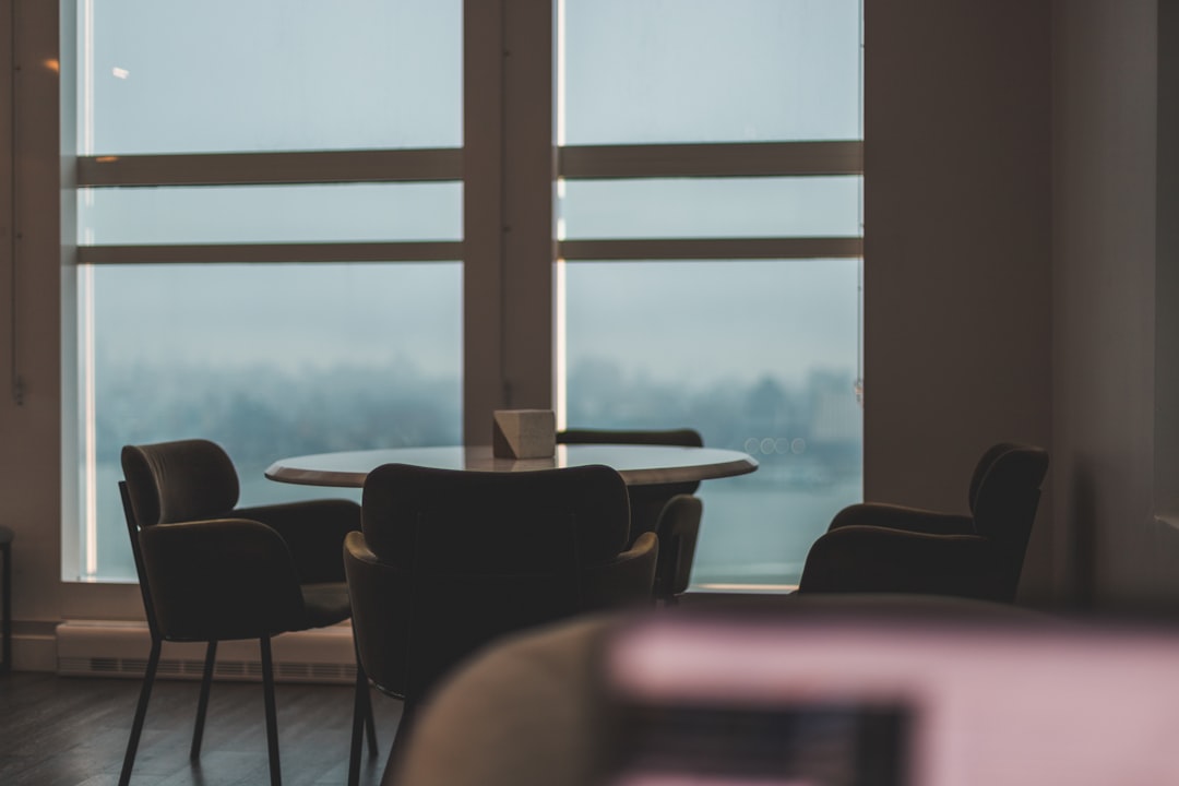 brown wooden chairs near window