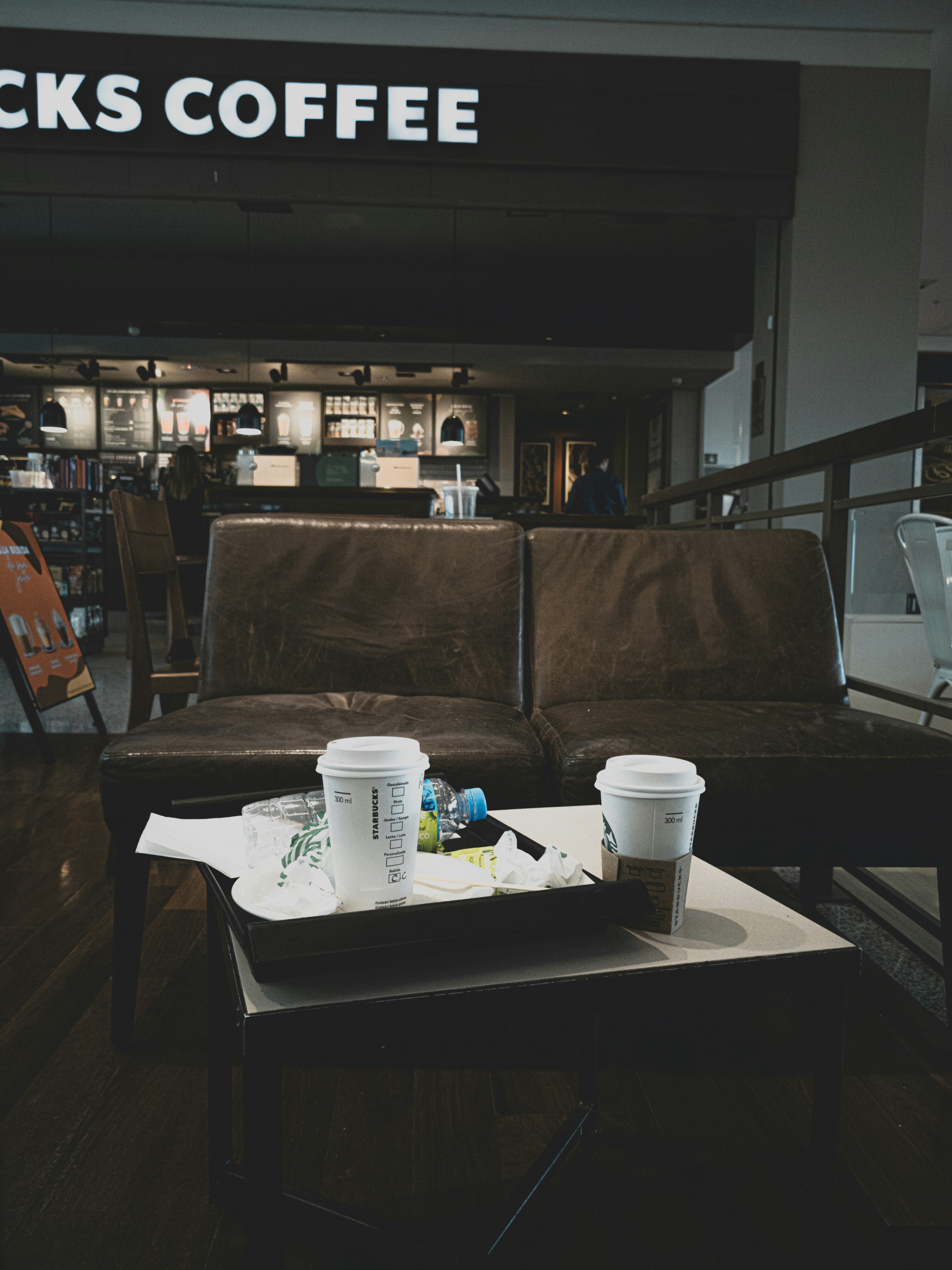 white ceramic mug on brown wooden table