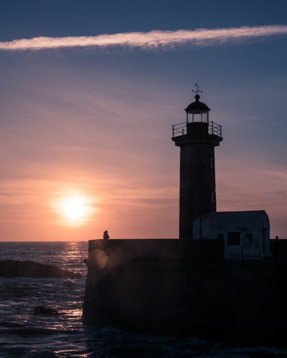 silhouette of lighthouse during sunset