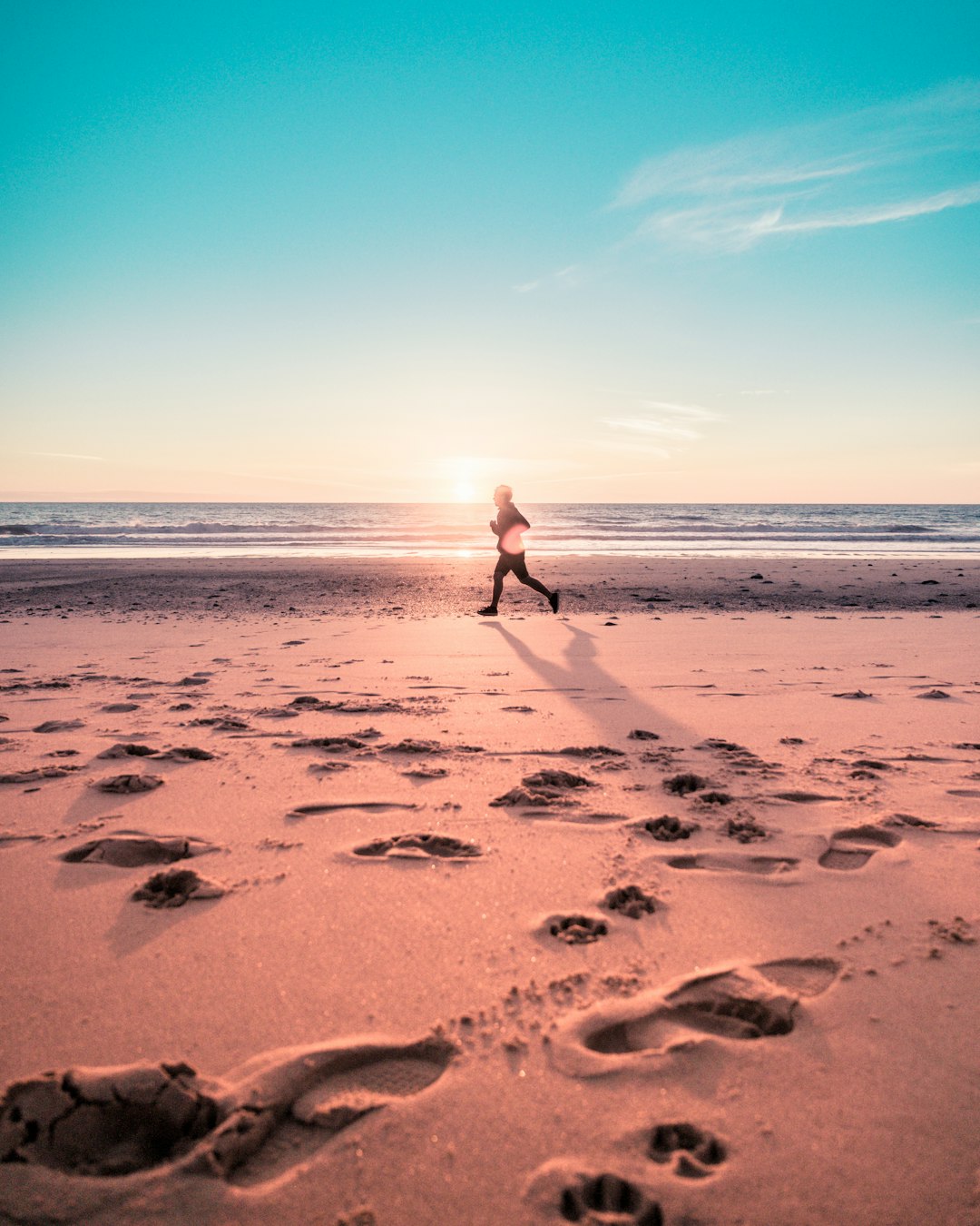 person walking on brown sand during daytime