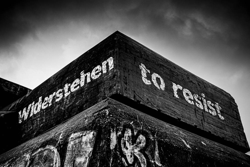 grayscale photo of love text on concrete wall