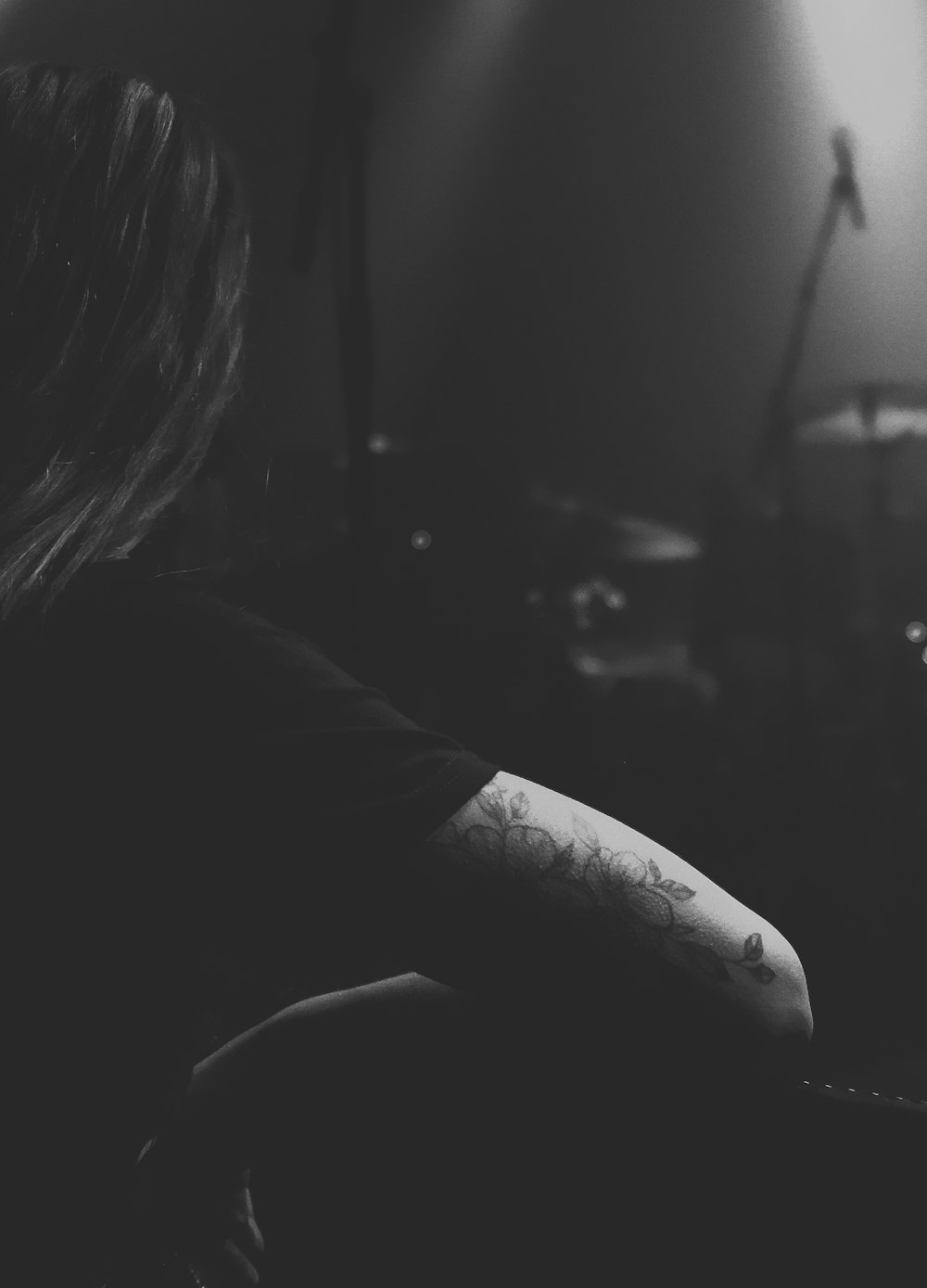 grayscale photo of person with tattoo on arm