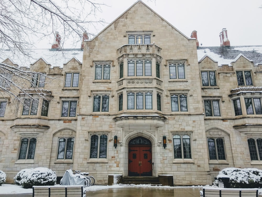 a large stone building with a red door