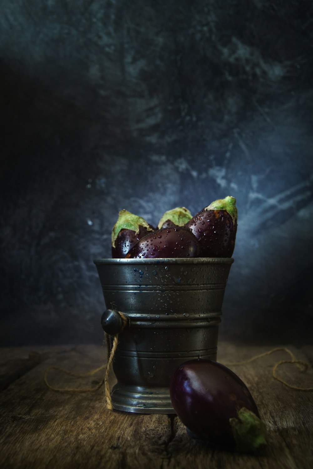 green and red fruit on black metal bucket