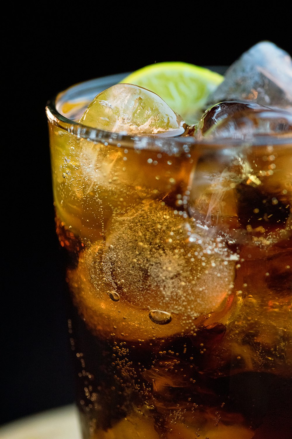 clear drinking glass with ice cubes and lemon