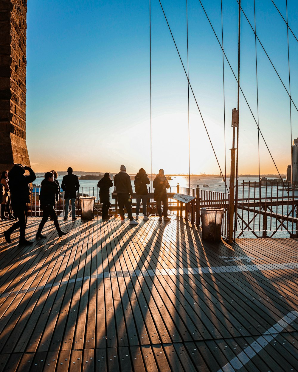 people walking on wooden bridge during daytime