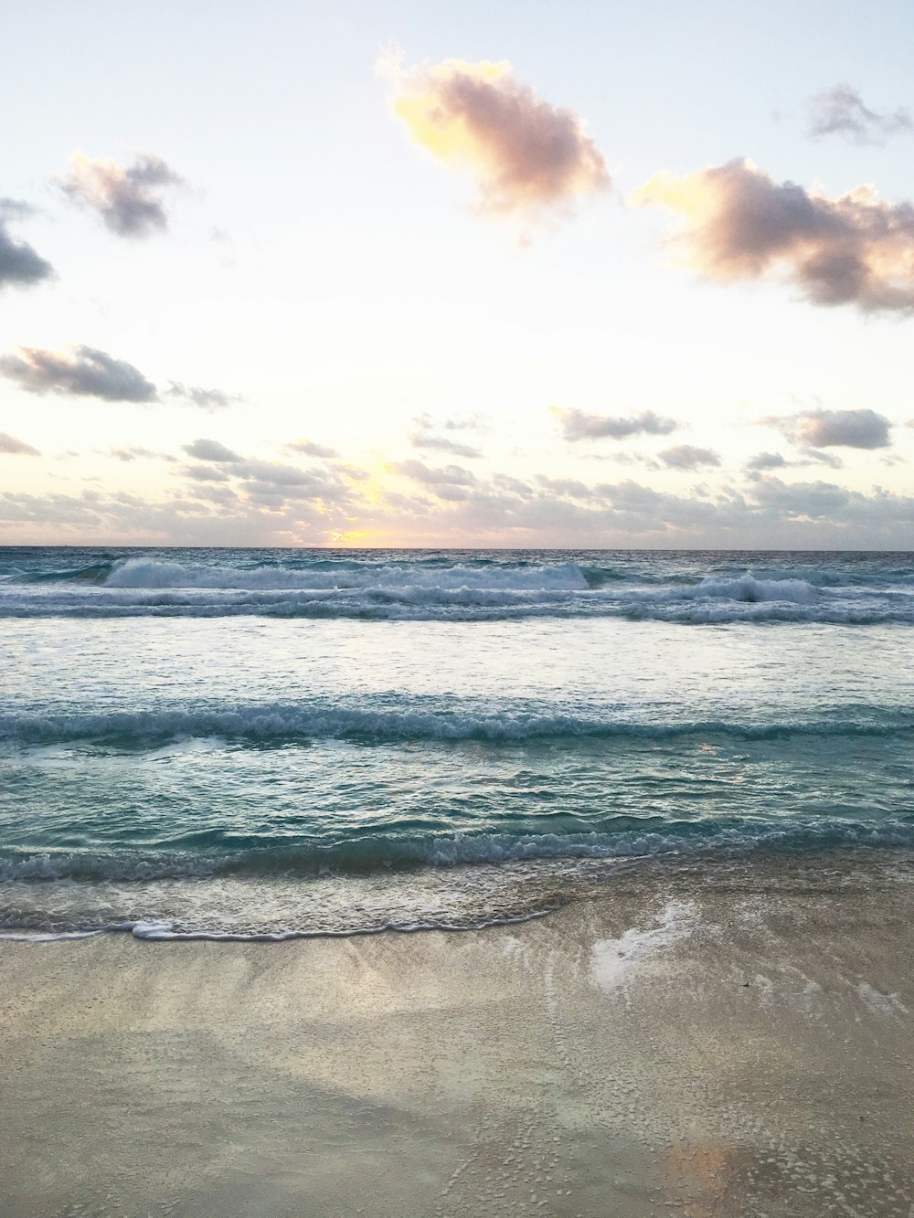 ocean waves crashing on shore during daytime