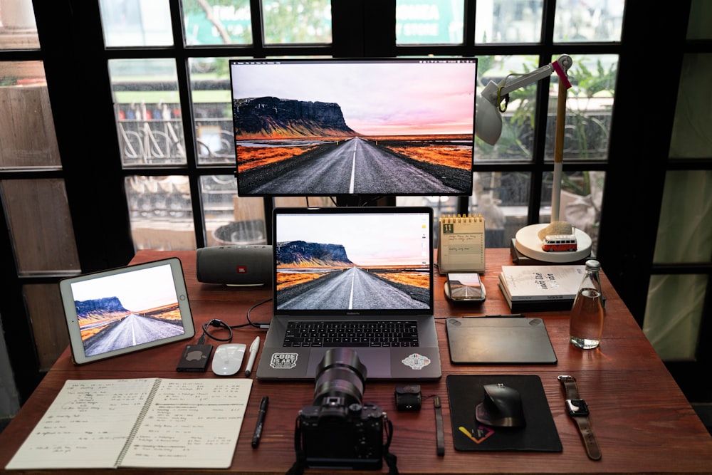 black laptop computer on brown wooden table