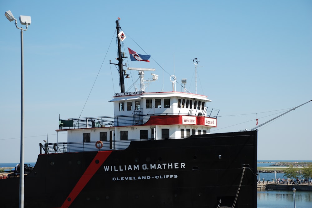 black and white ship on sea under blue sky during daytime