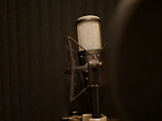 black and silver microphone on black textile