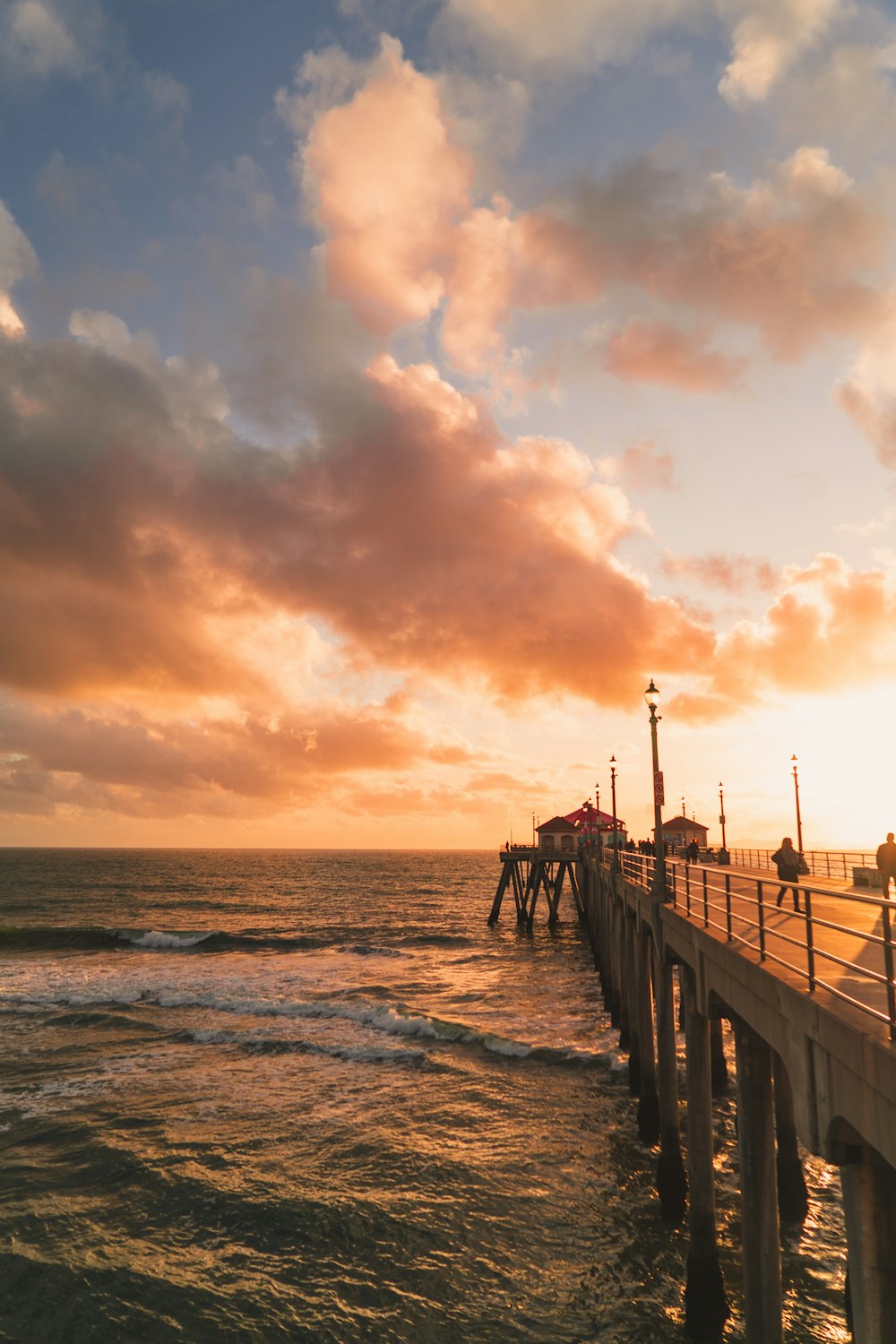 brown wooden dock on sea during sunset