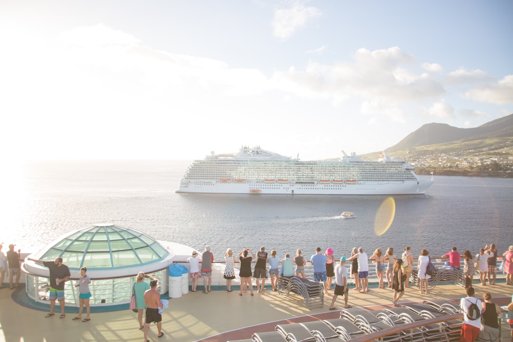 people walking on dock near white cruise ship during daytime