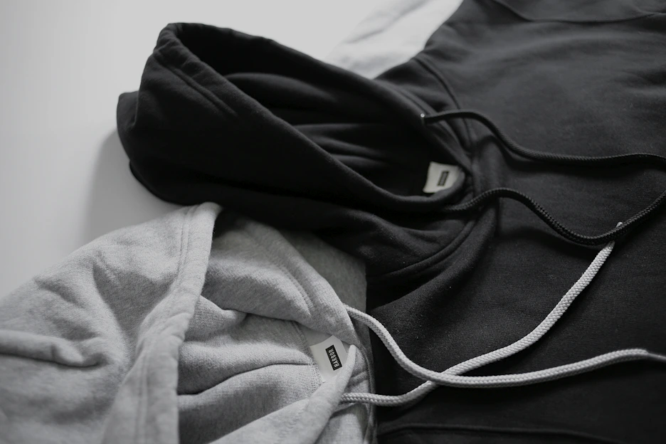 Close-up of a black and white vergesti hoodie with sleek logo embroidery on a white background