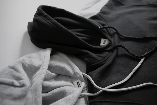 Minimalistic black and white hoodie elegantly displayed on a simple backdrop