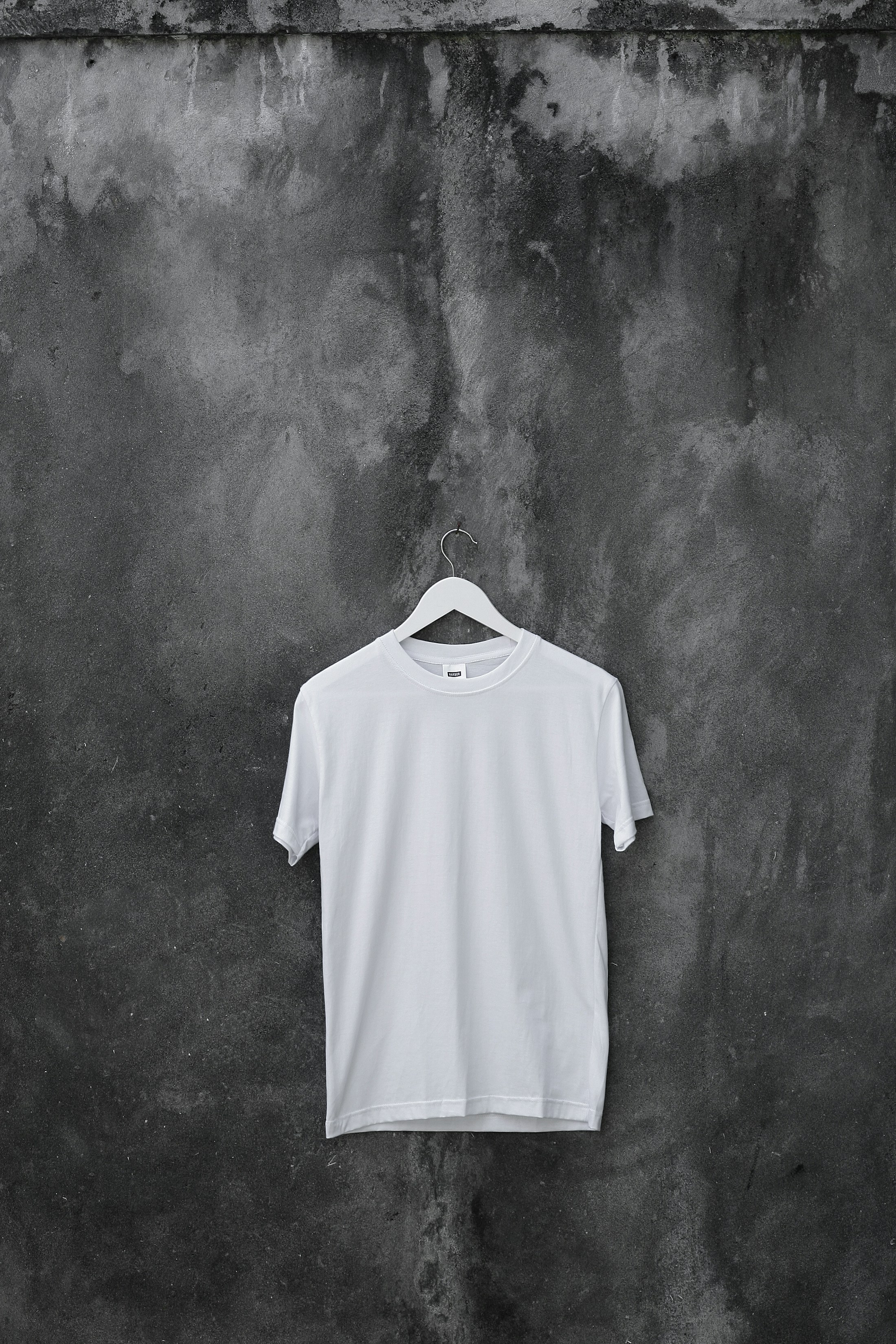 A heavyweight tee, hung against weathered concrete