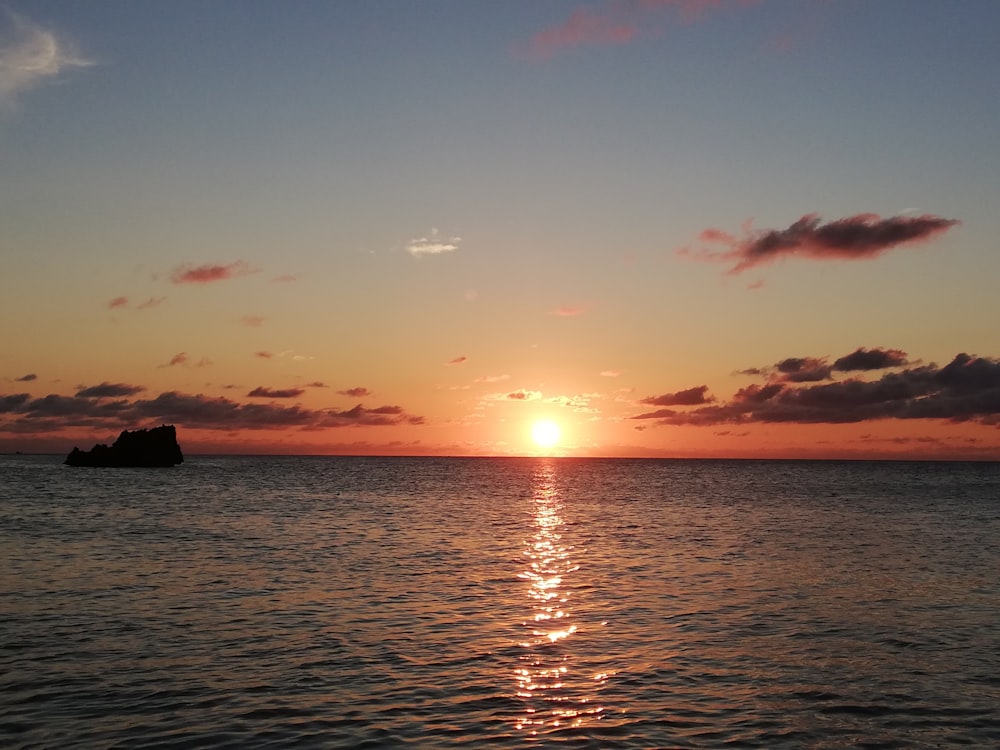 body of water during sunset