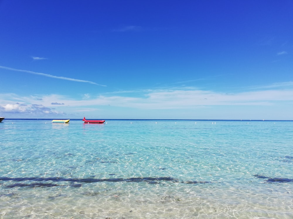 昼間の青空に浮かぶ赤い船