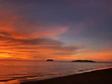 A stunning sunset view over the pristine beaches of Lombok with clear orange and pink skies