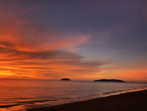 A stunning sunset view over the pristine beaches of Lombok with clear orange and pink skies